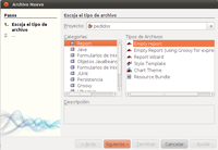 Ventana de NetBeans para añadir un informe a un proyecto. Está dividida en dos zonas. A la izquierda aparece el texto pasos y debajo escoja el tipo de archivo..., a la derecha bajo el mismo texto de escoja el tipo de archivo aparece proyecto y en un rectángulo blanco pedidos, y debajo  un bloque de categorías, entre las que aparece destacada report y a la derecha un conjunto de tipos de archivos entre los que aparece destacado empty report.  Debajo aparecen botones para ir atrás, a siguiente (está destacado en naranja), terminar, cancelar y ayuda.