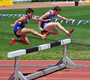 Dos corredores saltando obstáculos.