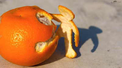 Imagen que muestra una naranja donde se ha recortado a piel formando una figura humana.