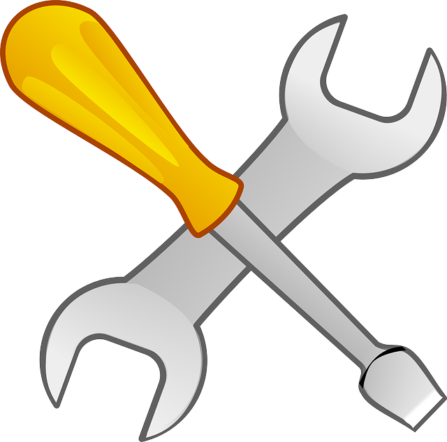 Ilustración de un destornillador y una llave fija, cruzados en forma de X.